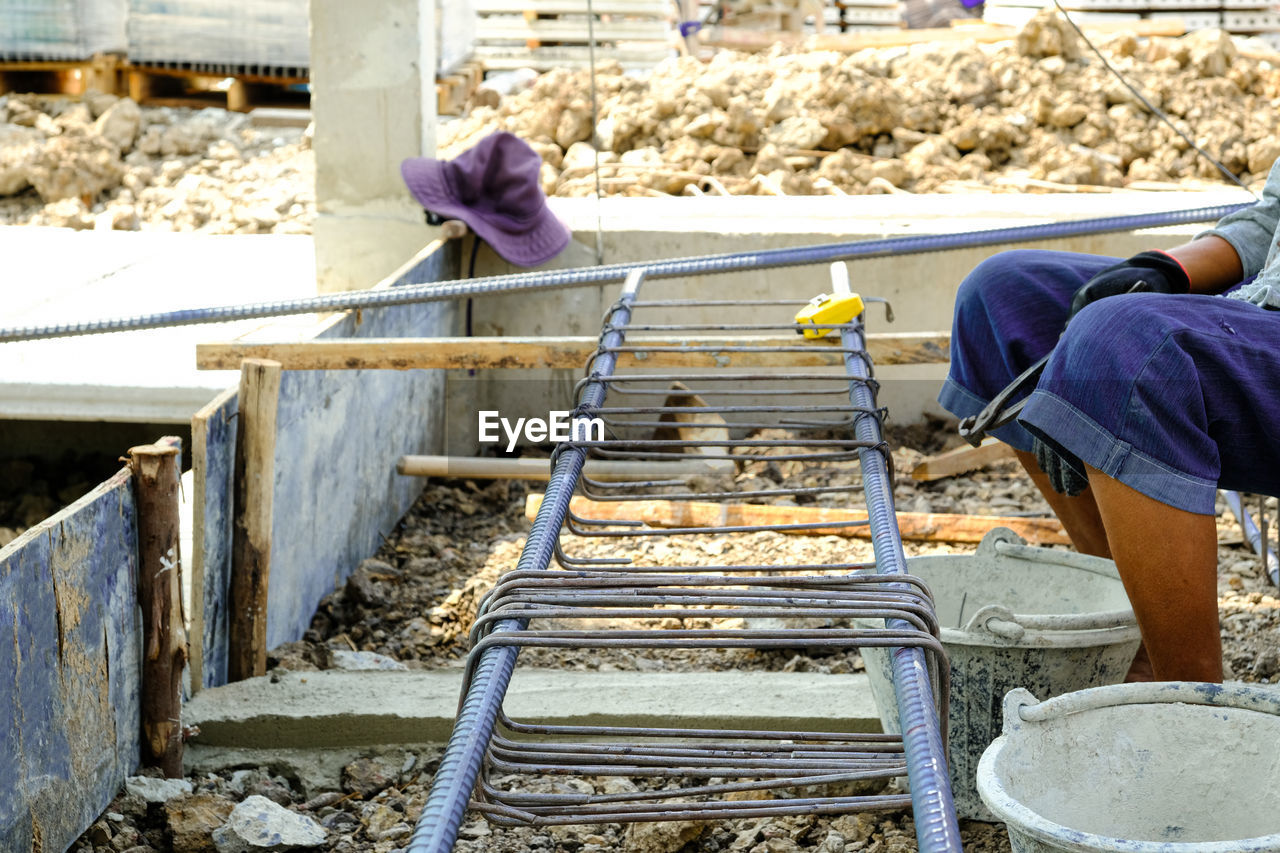 REAR VIEW OF MAN WORKING AT STAIRCASE