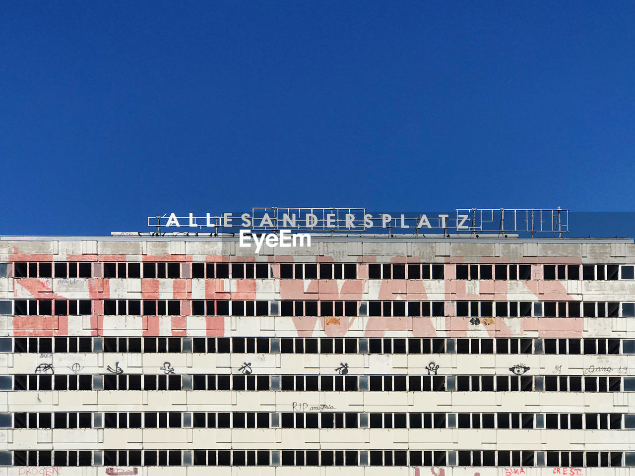 LOW ANGLE VIEW OF BUILDINGS AGAINST CLEAR BLUE SKY