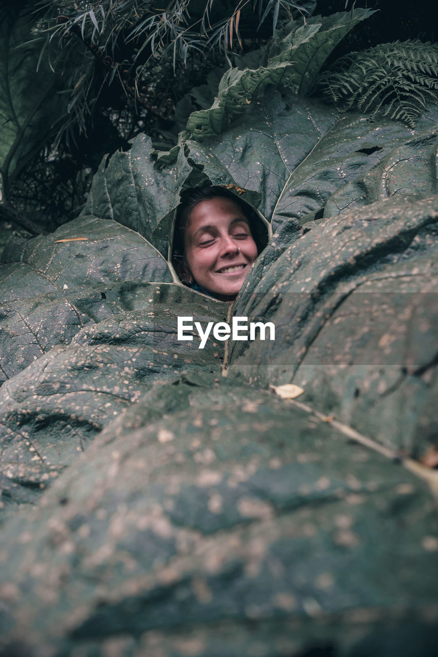 Portrait of smiling woman amidst plants