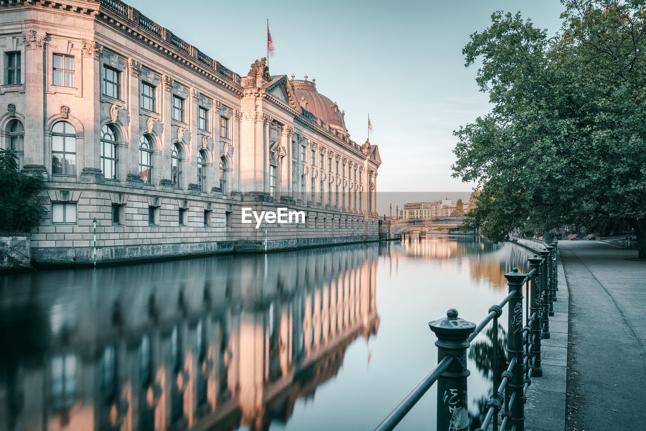 Bode-museum by spree river in city against clear sky