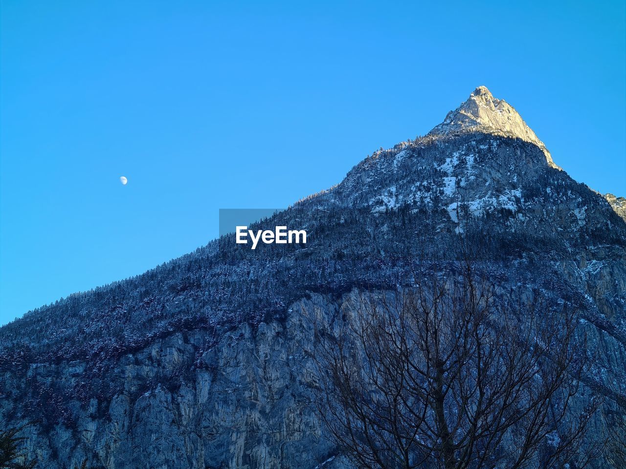 Scenic view of mountains against clear blue sky