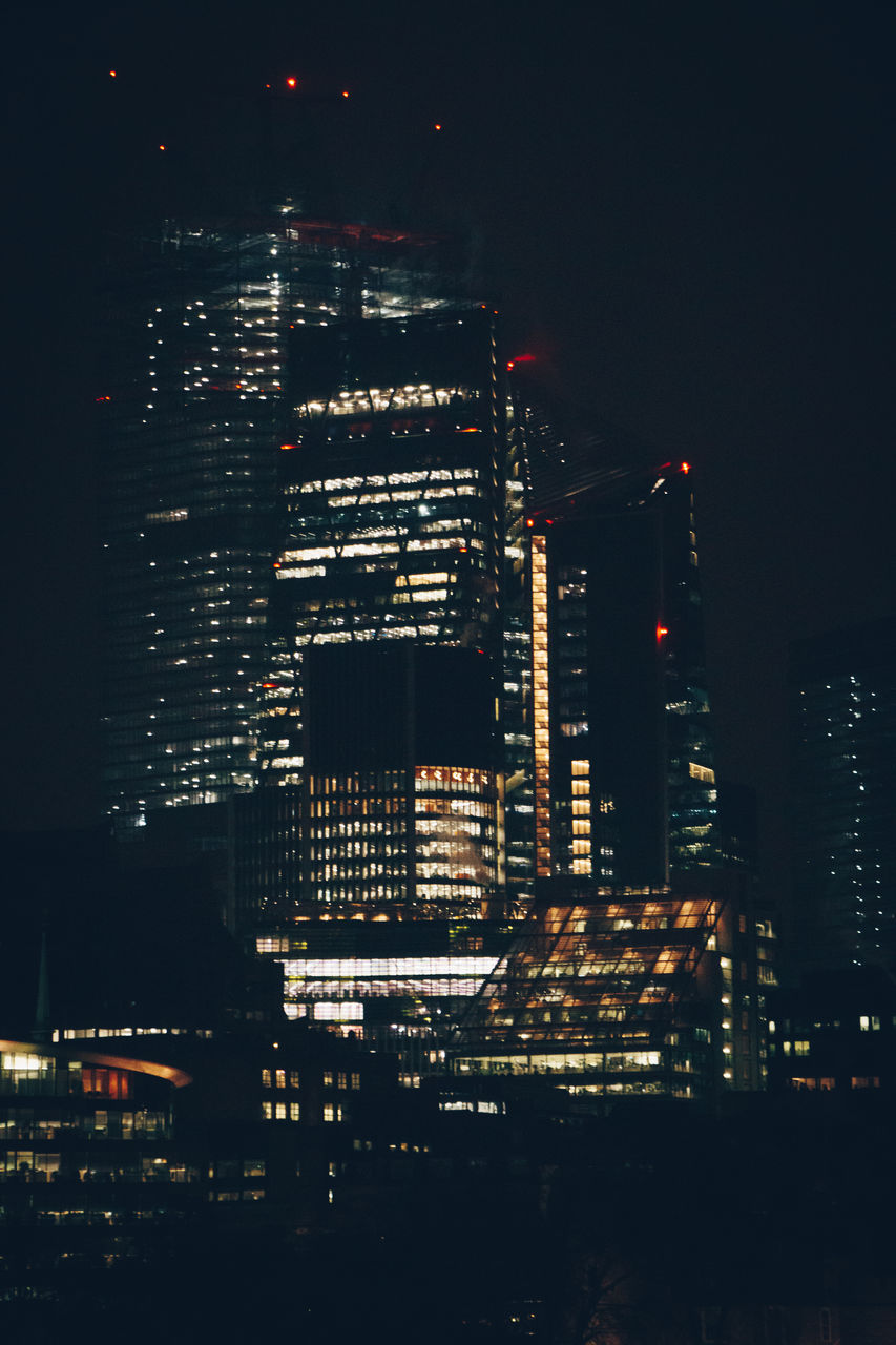 Aerial view of illuminated buildings in city at night