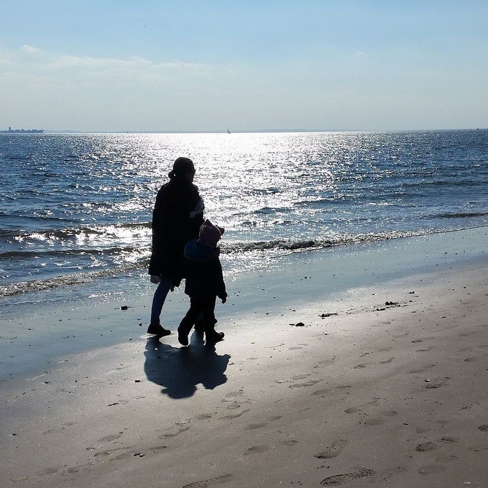 SILHOUETTE OF PEOPLE ON BEACH