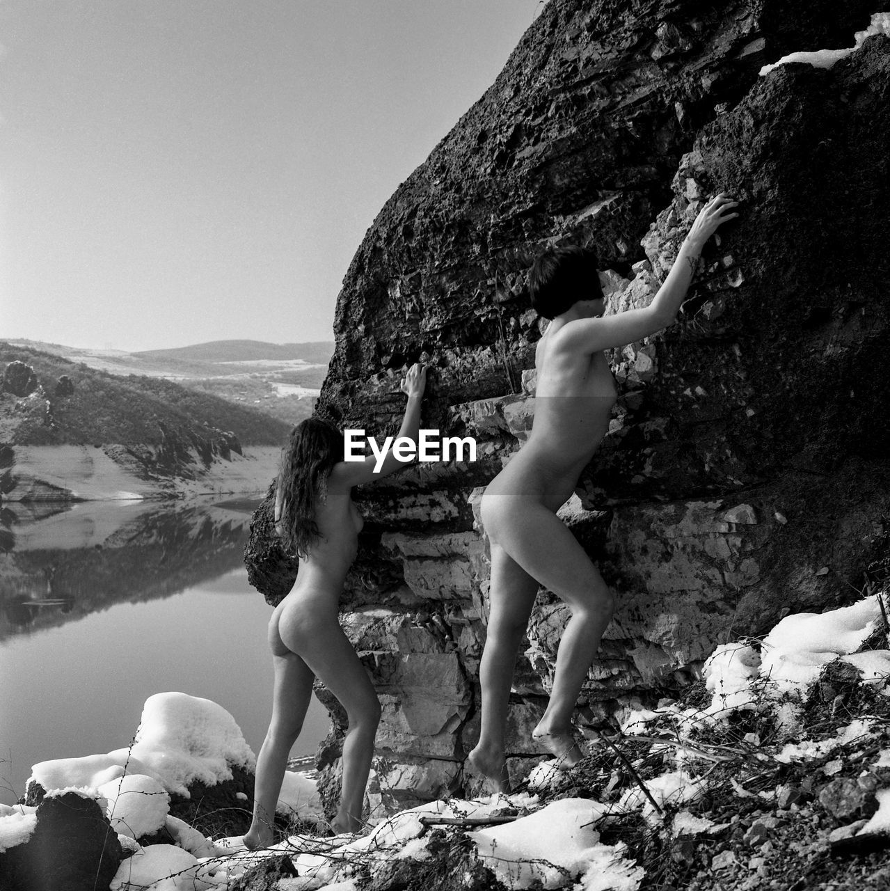 Side view of woman walking on rock against mountain