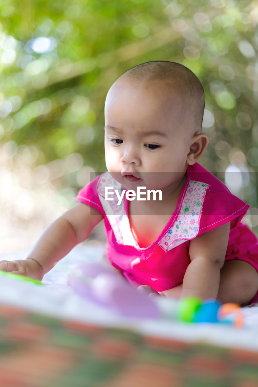 Cute baby girl playing at park