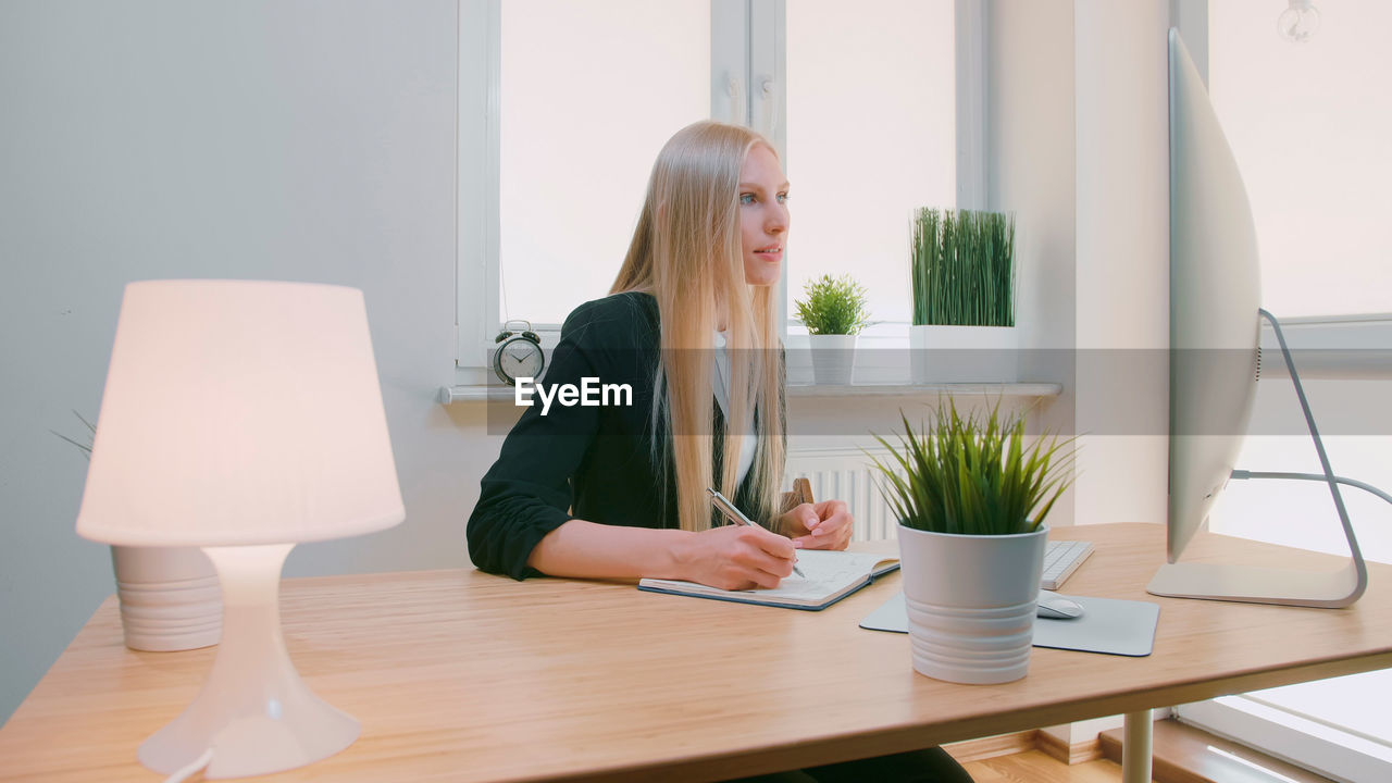 Young woman using laptop on table