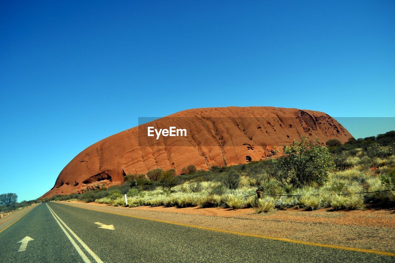 Empty road along rocky mountain