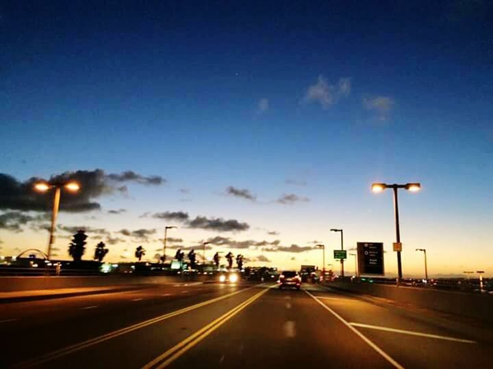 ROAD PASSING THROUGH CITY AT NIGHT