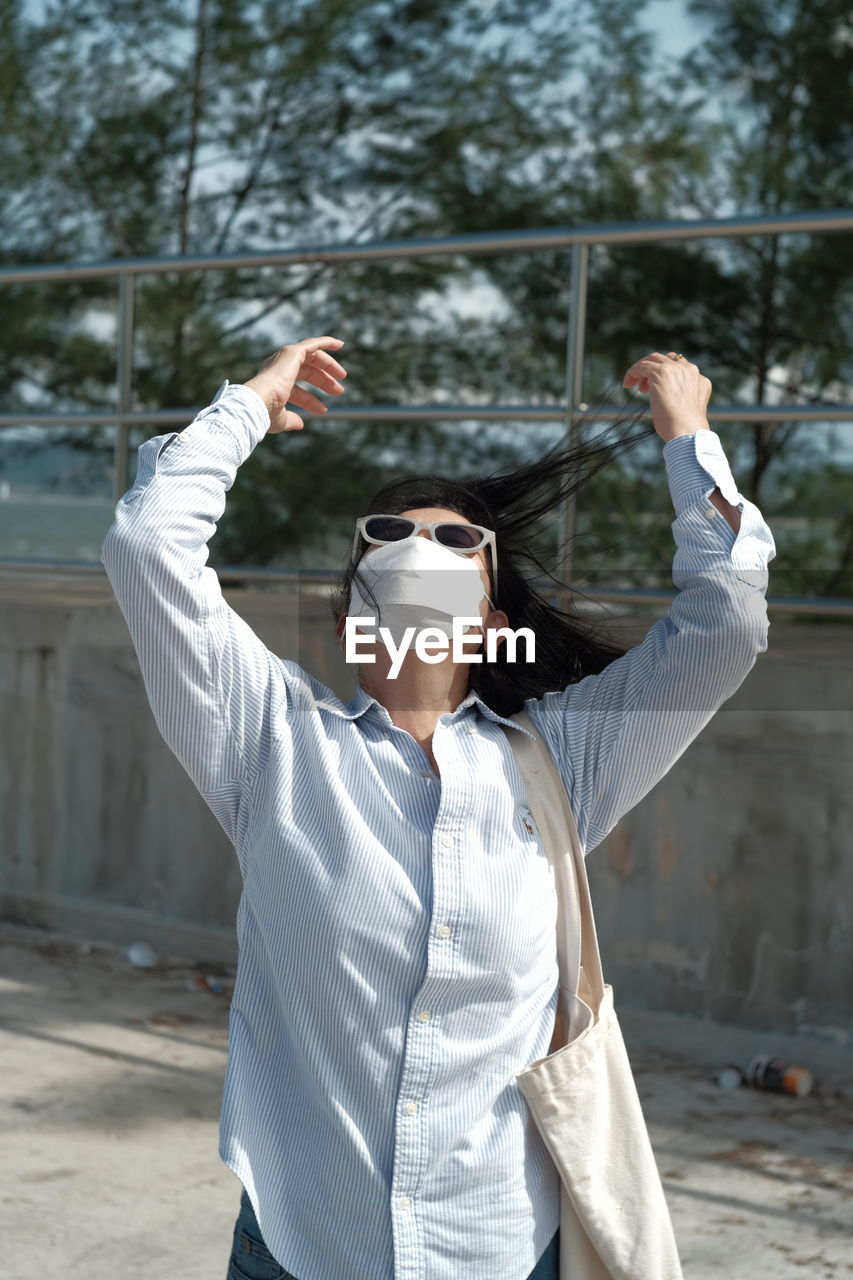 rear view of man standing by railing