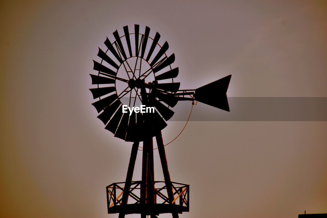 LOW ANGLE VIEW OF SILHOUETTE TRADITIONAL WINDMILL AGAINST SKY