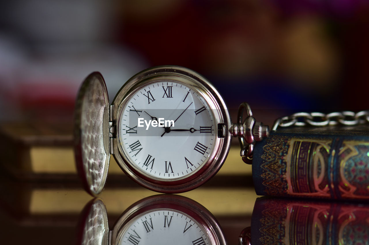 Close-up of pocket watch on table