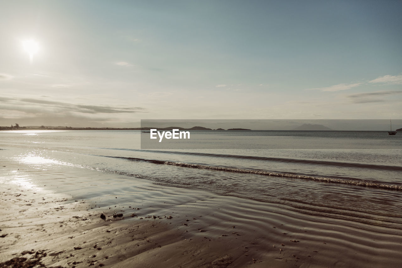 Scenic view of beach against sky during sunset