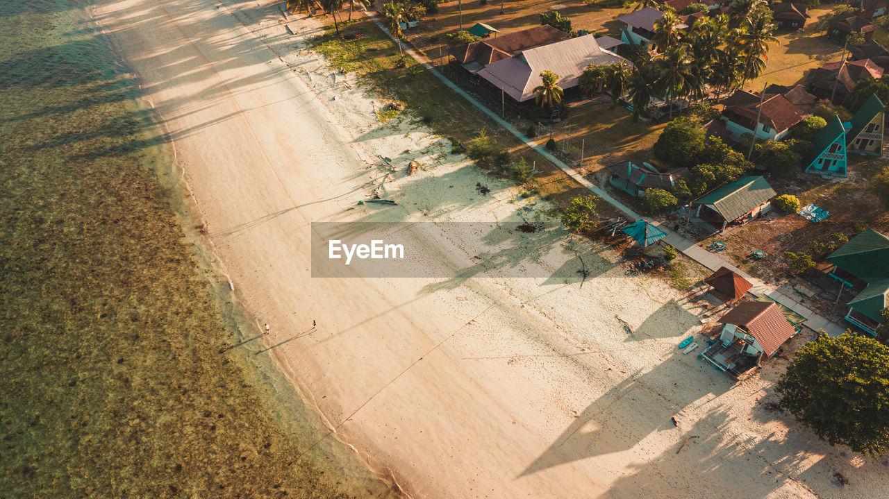 aerial photography, high angle view, aerial view, agriculture, landscape, land, nature, plant, architecture, rural scene, environment, field, sunlight, farm, outdoors, day, city, building exterior, built structure, residential area, tree, crop, growth, transportation, no people, building, urban area, suburb