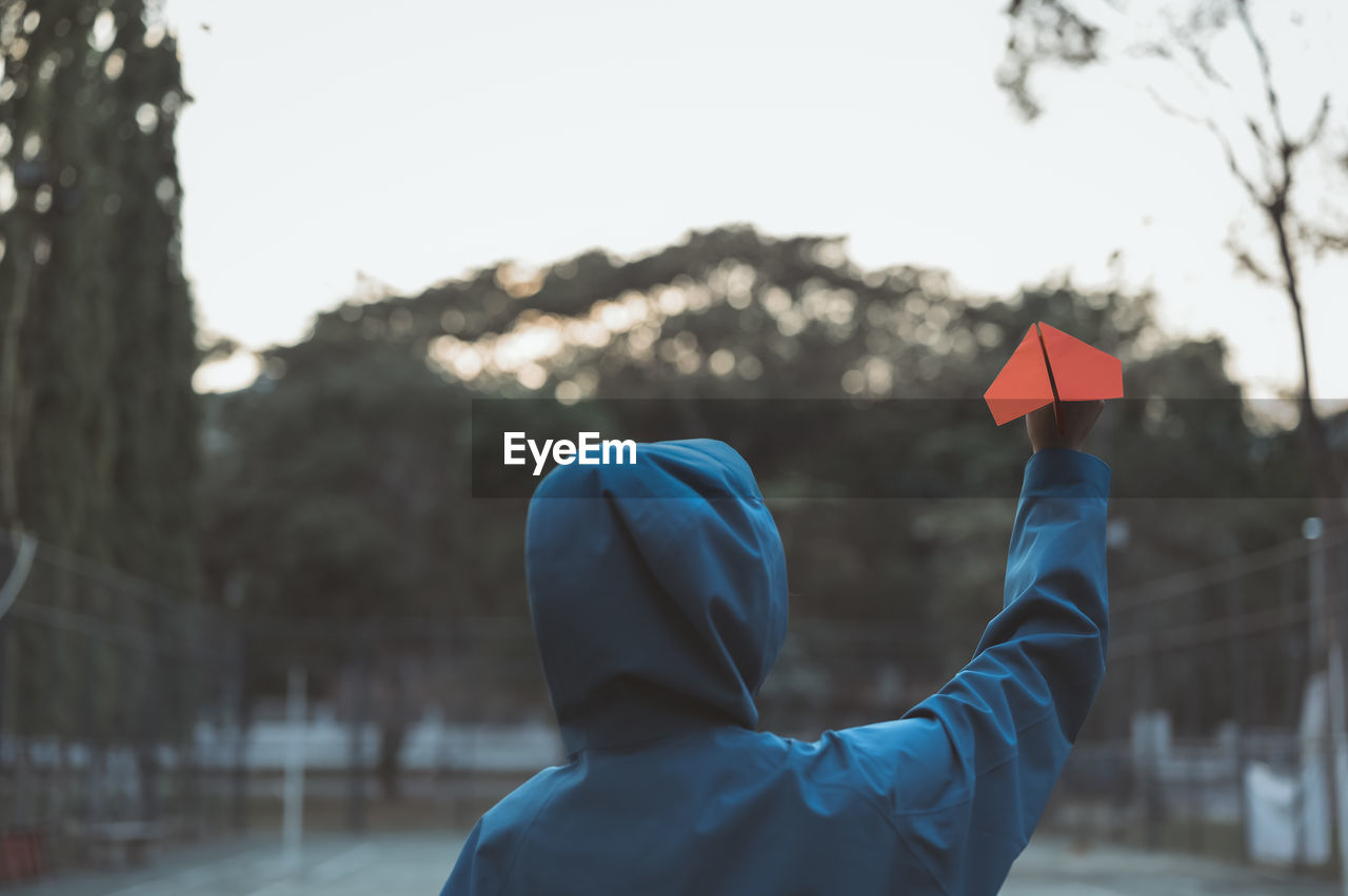 Young women in hoodie holding paper aircraft  prepare for throwing , hope and dream concept