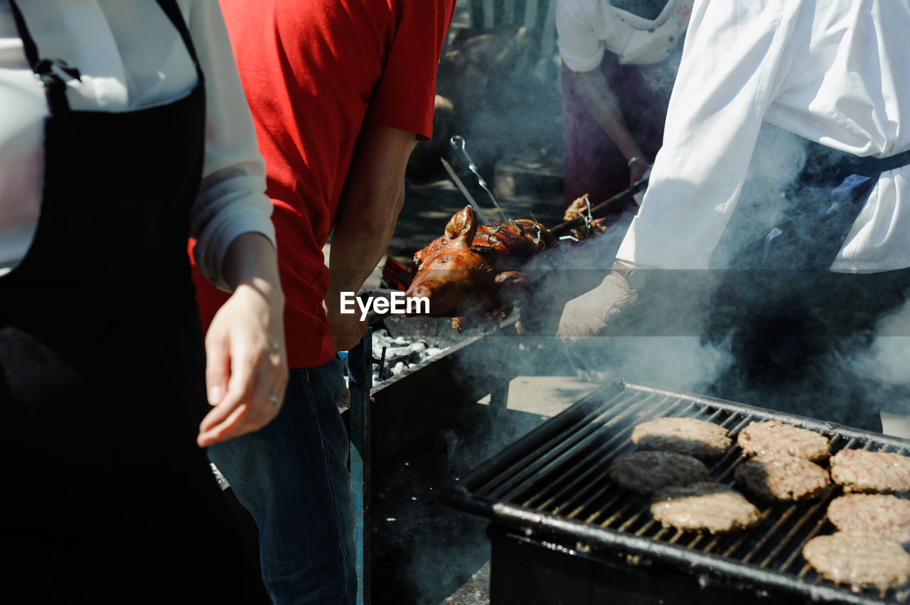 People preparing food outdoors