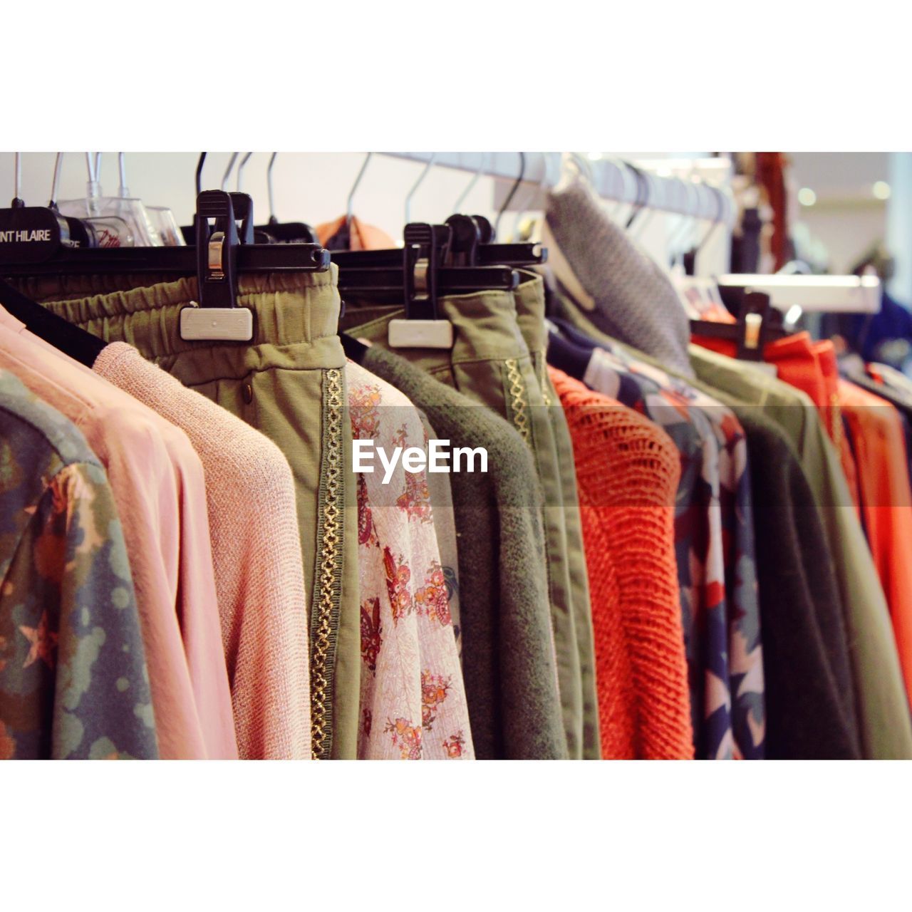 CLOSE-UP OF CLOTHES HANGING IN STORE