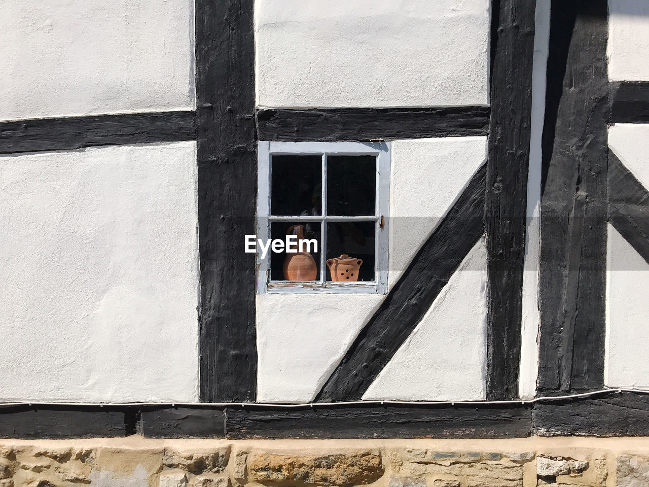 Window in historic timber framed black and white building wall