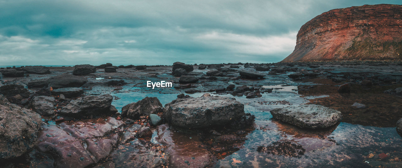 Scenic view of sea against cloudy sky