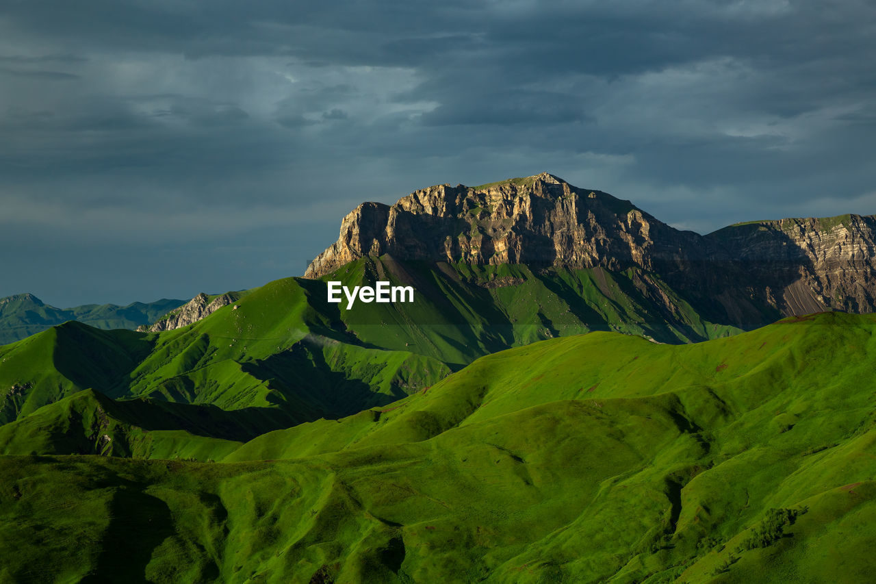 Beautiful green mountains. scenic view of mountain against sky