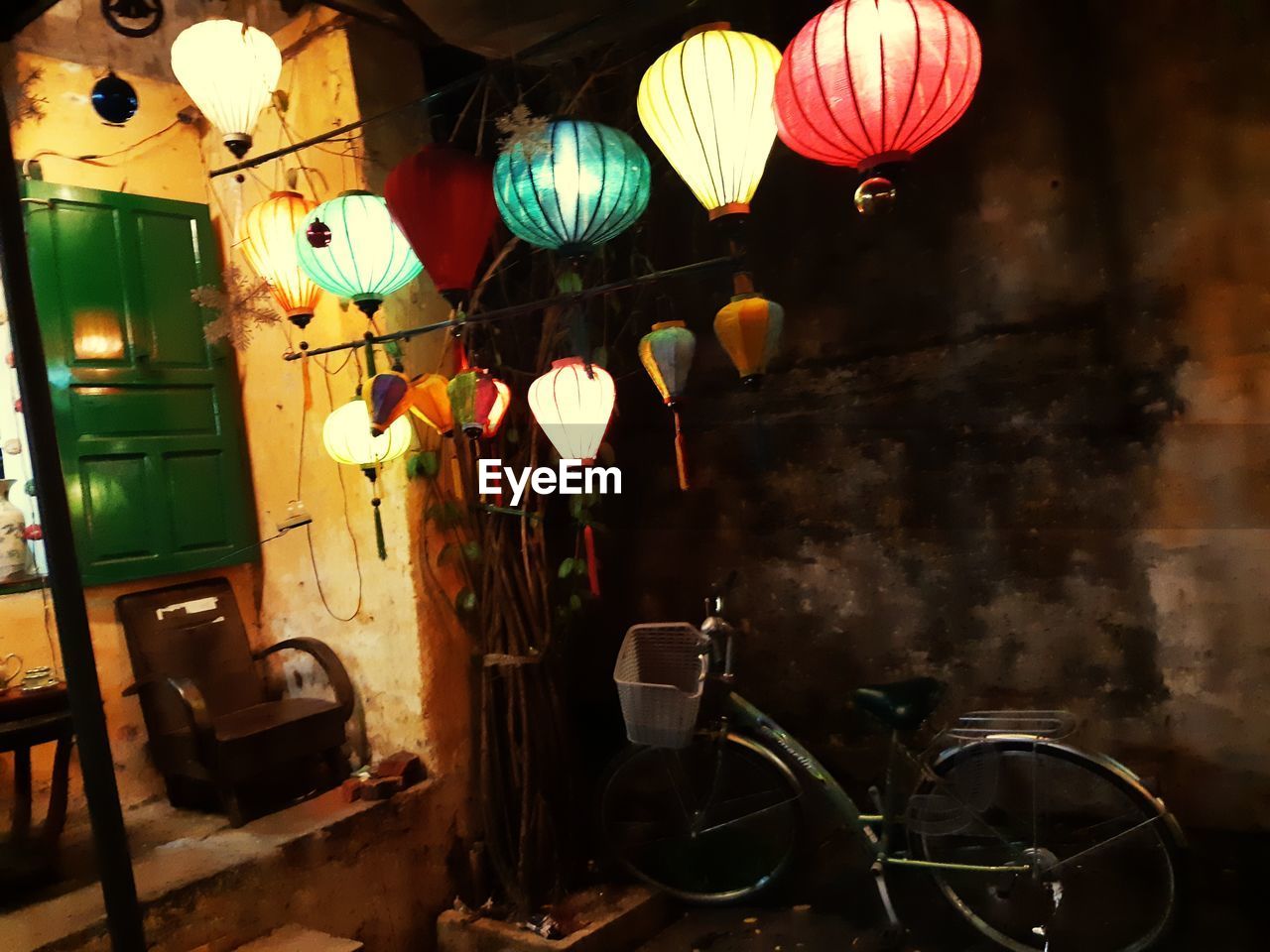 ILLUMINATED LANTERNS HANGING ON WALL