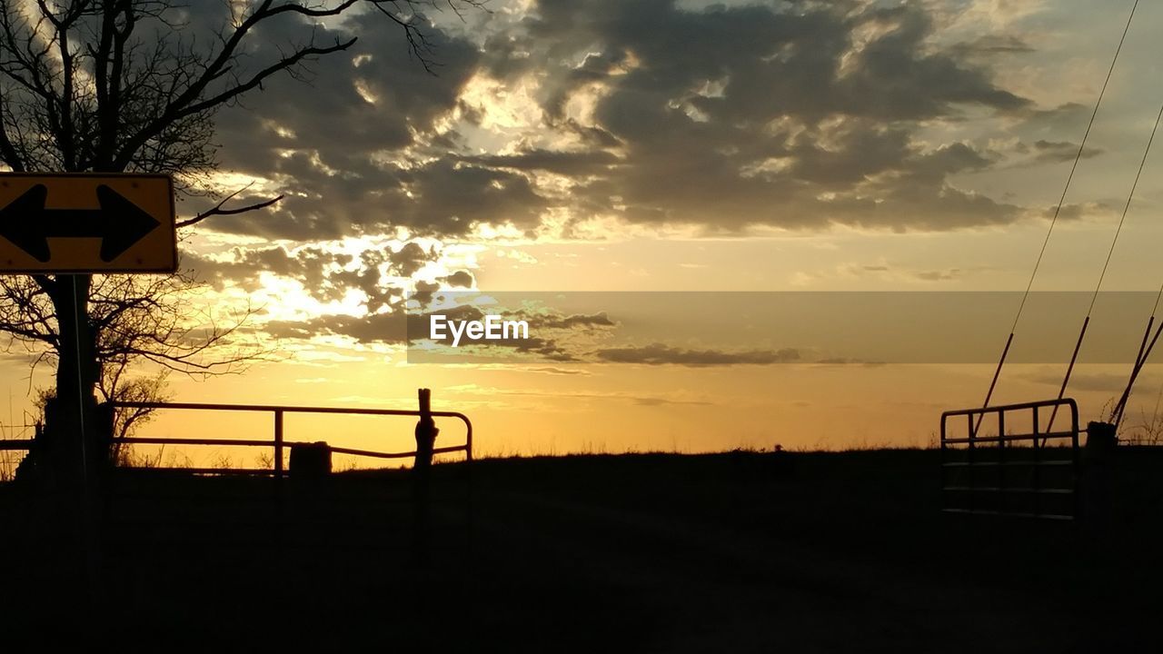 SILHOUETTE OF SIGN AT SUNSET