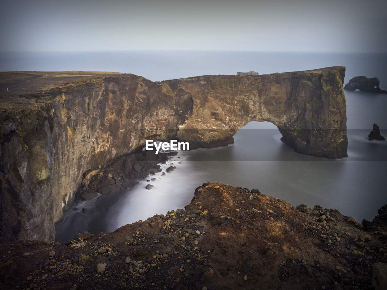 Rock formations by sea against sky