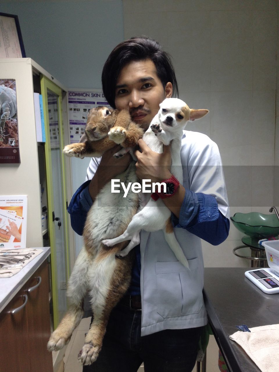 PORTRAIT OF YOUNG MAN STANDING IN HOME