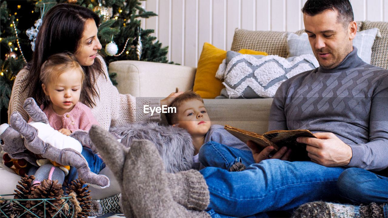 FATHER AND SON SITTING ON SOFA