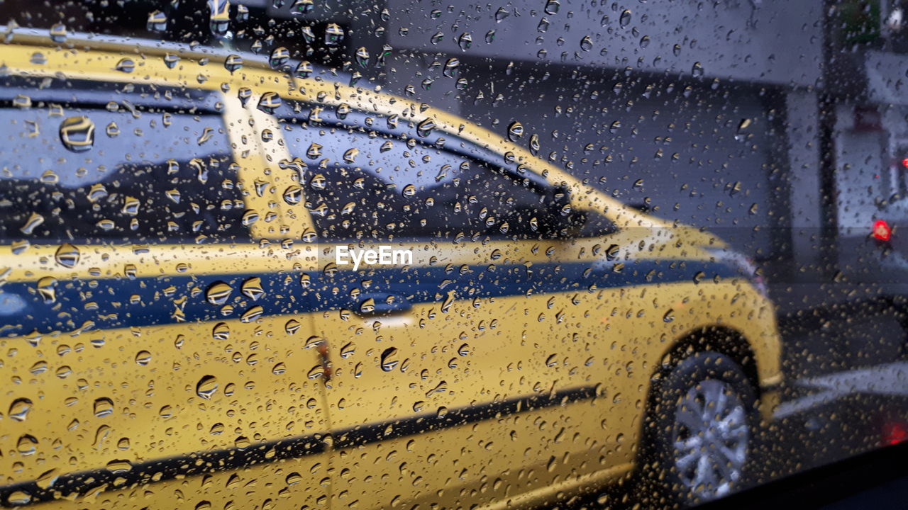 WATER DROPS ON GLASS WINDOW OF CAR