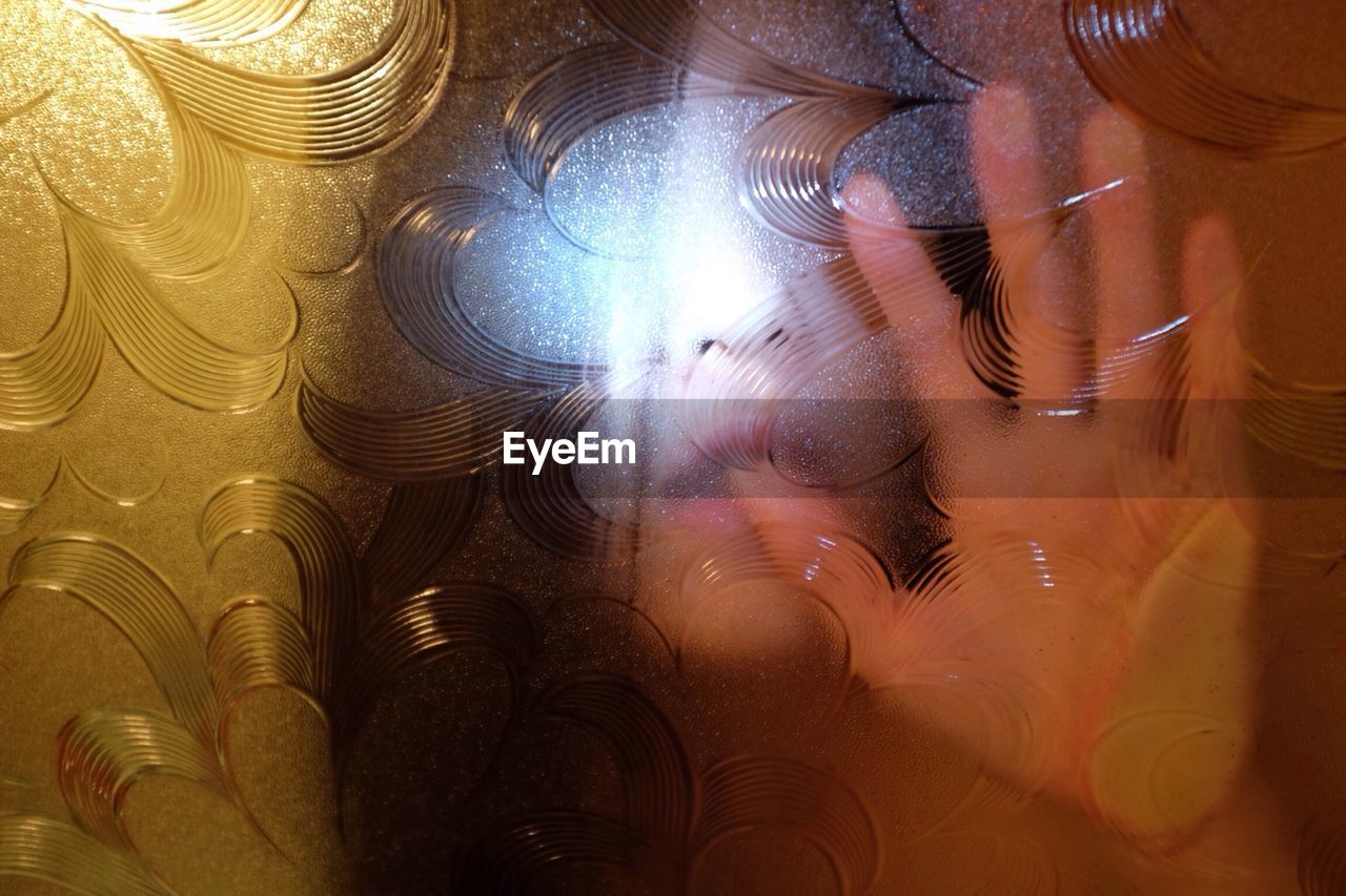 Close-up of woman seen through glass