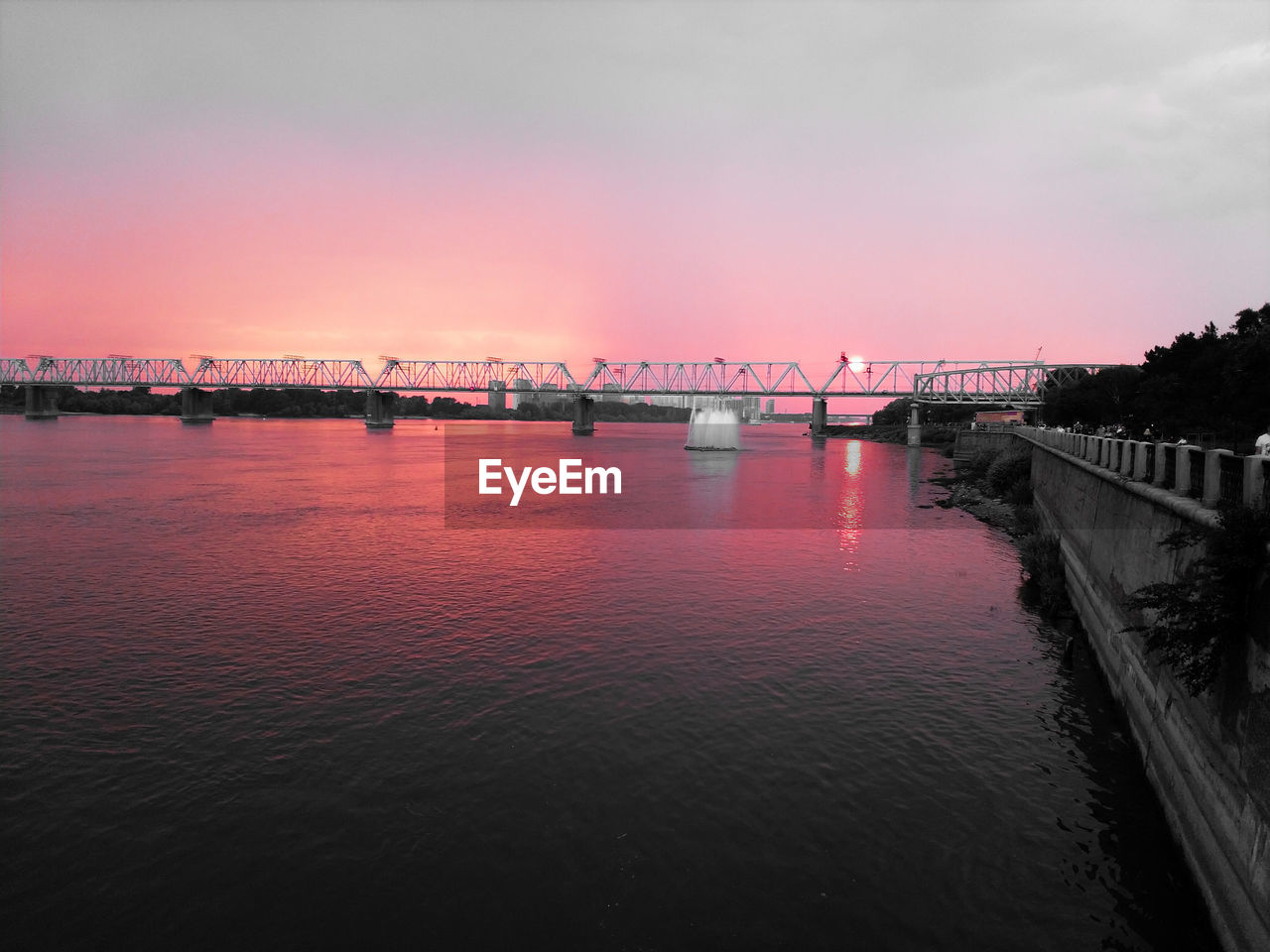 VIEW OF BRIDGE OVER RIVER AGAINST SKY DURING SUNSET