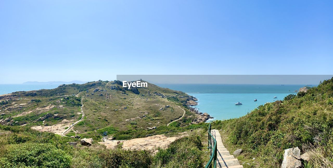 PANORAMIC SHOT OF SEA AGAINST CLEAR BLUE SKY