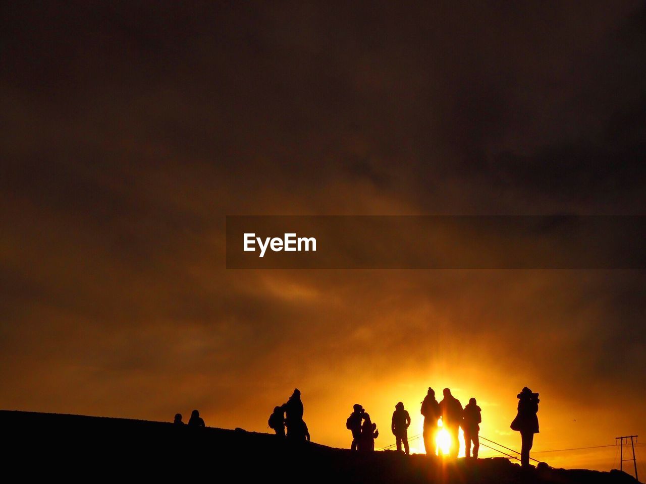 Silhouette people against sky during sunset