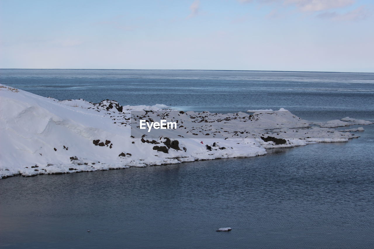 Scenic view of sea against sky during winter