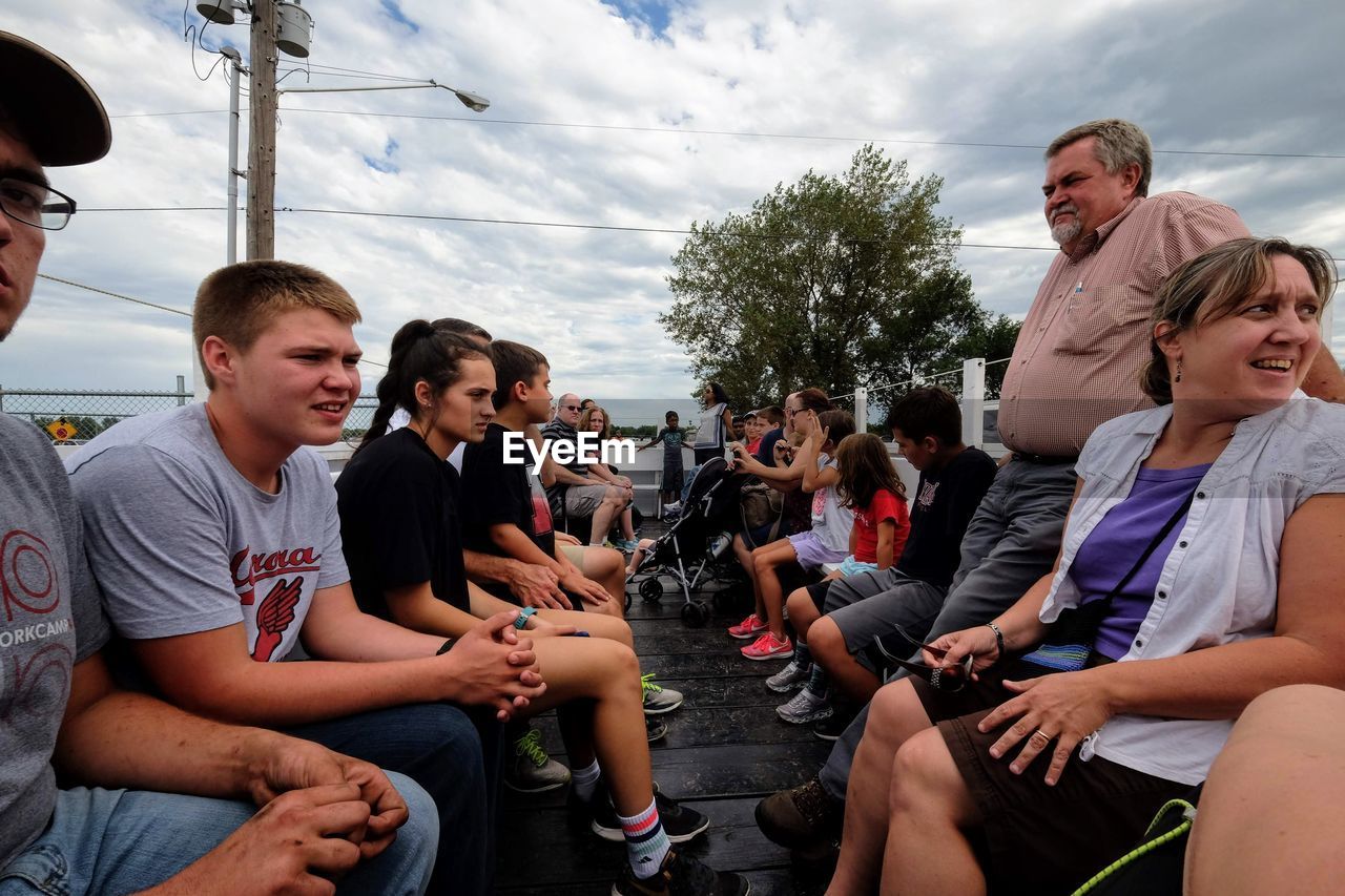 GROUP OF FRIENDS SITTING ON A OUTDOORS