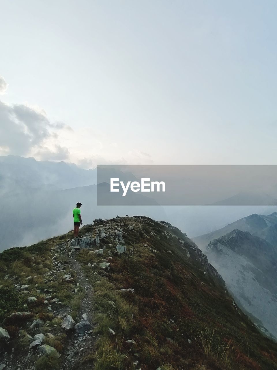 Man on rock against sky