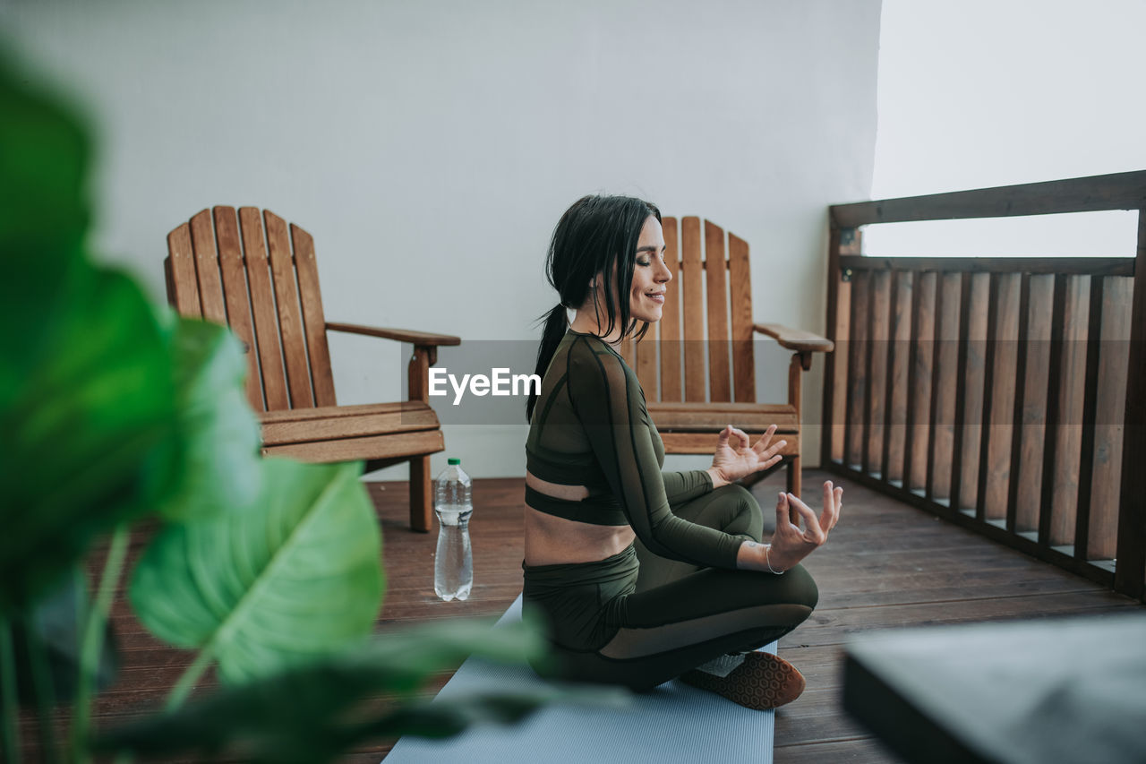 Woman sitting on table at home