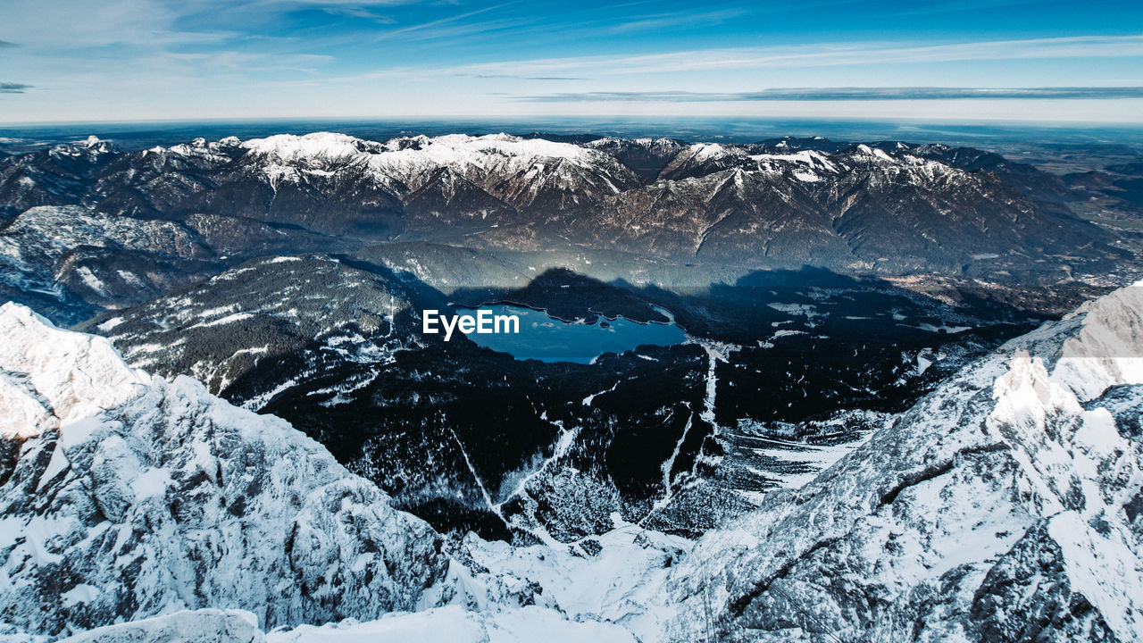 Aerial view of snowcapped mountains against sky