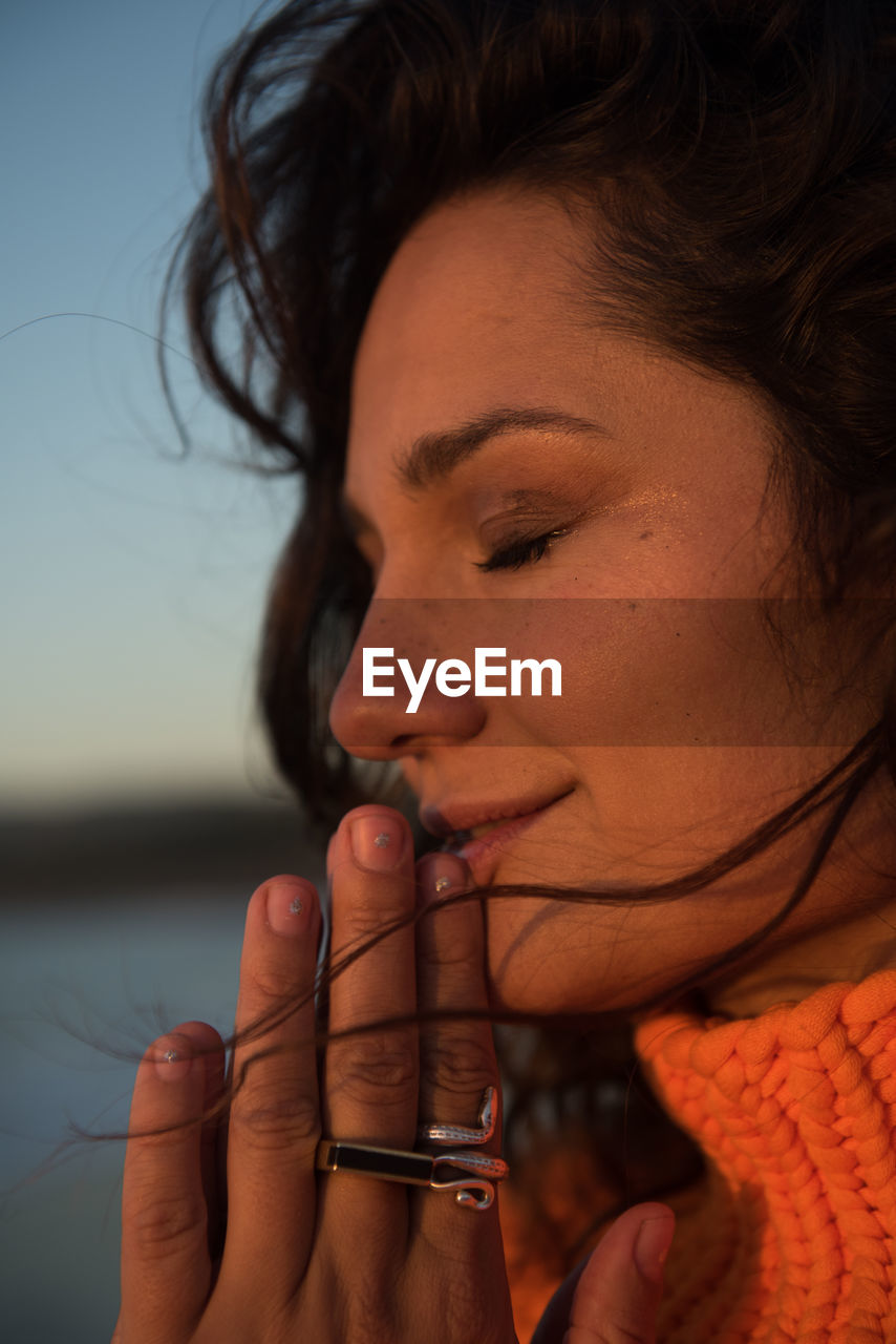 Peaceful woman takes in the view at sunset