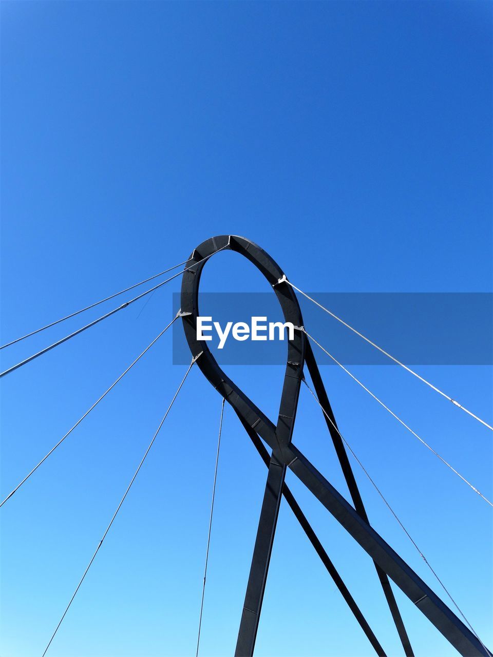 LOW ANGLE VIEW OF CABLES AGAINST CLEAR BLUE SKY