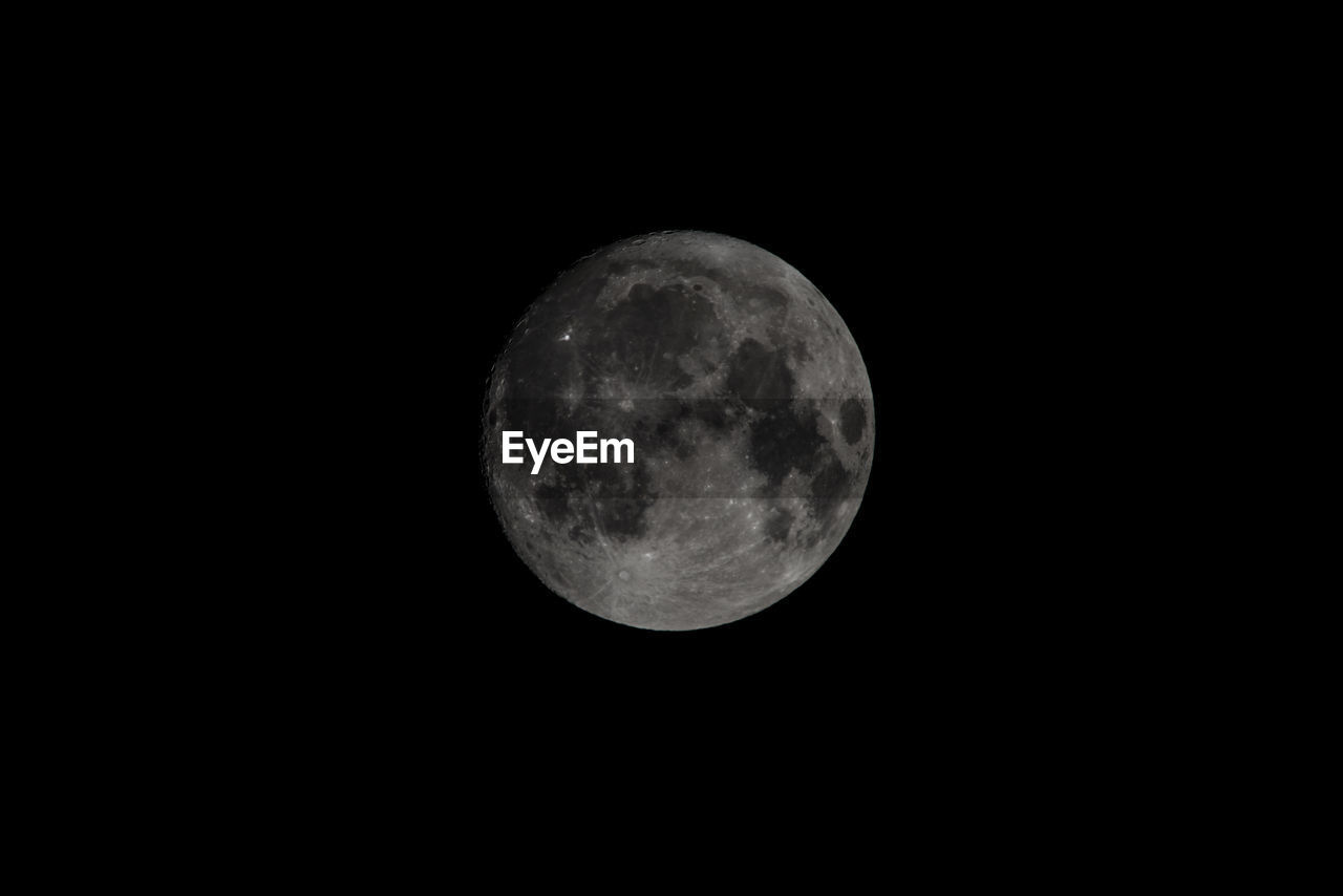 Low angle view of moon against sky at night