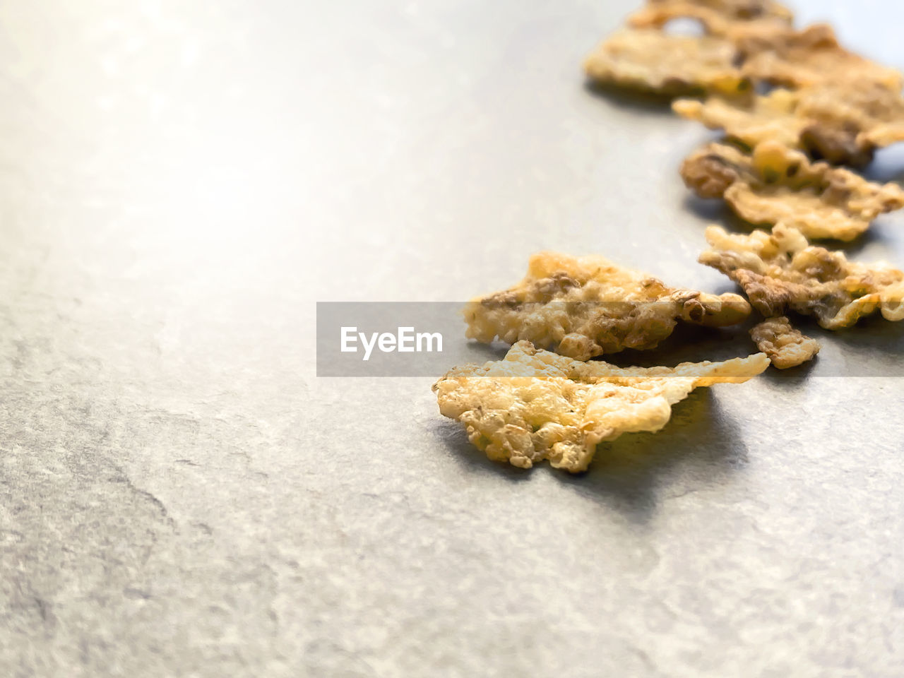 A group of corn flakes on a gray floor. daily breakfast and nutrition