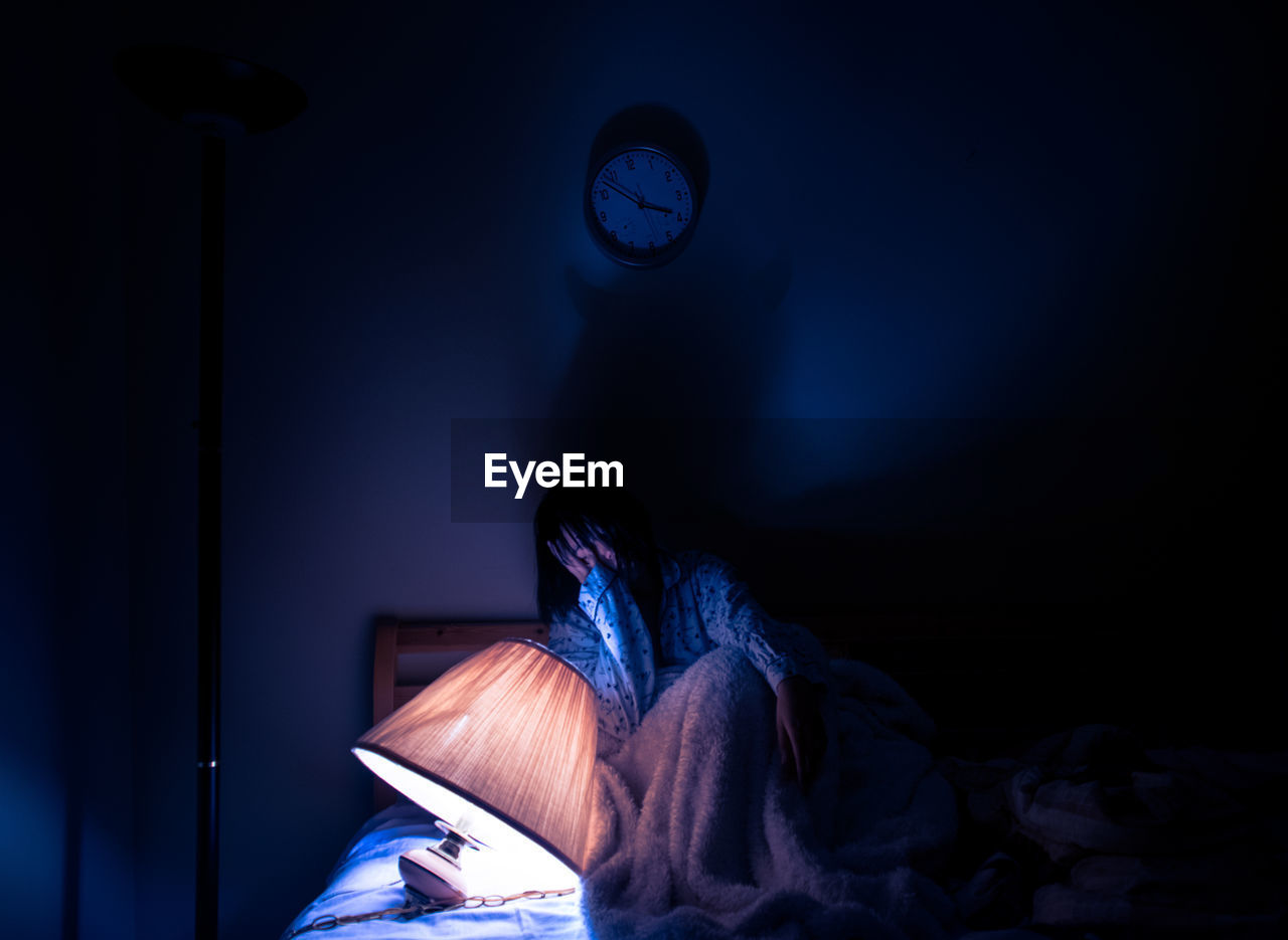 Woman relaxing on bed at home