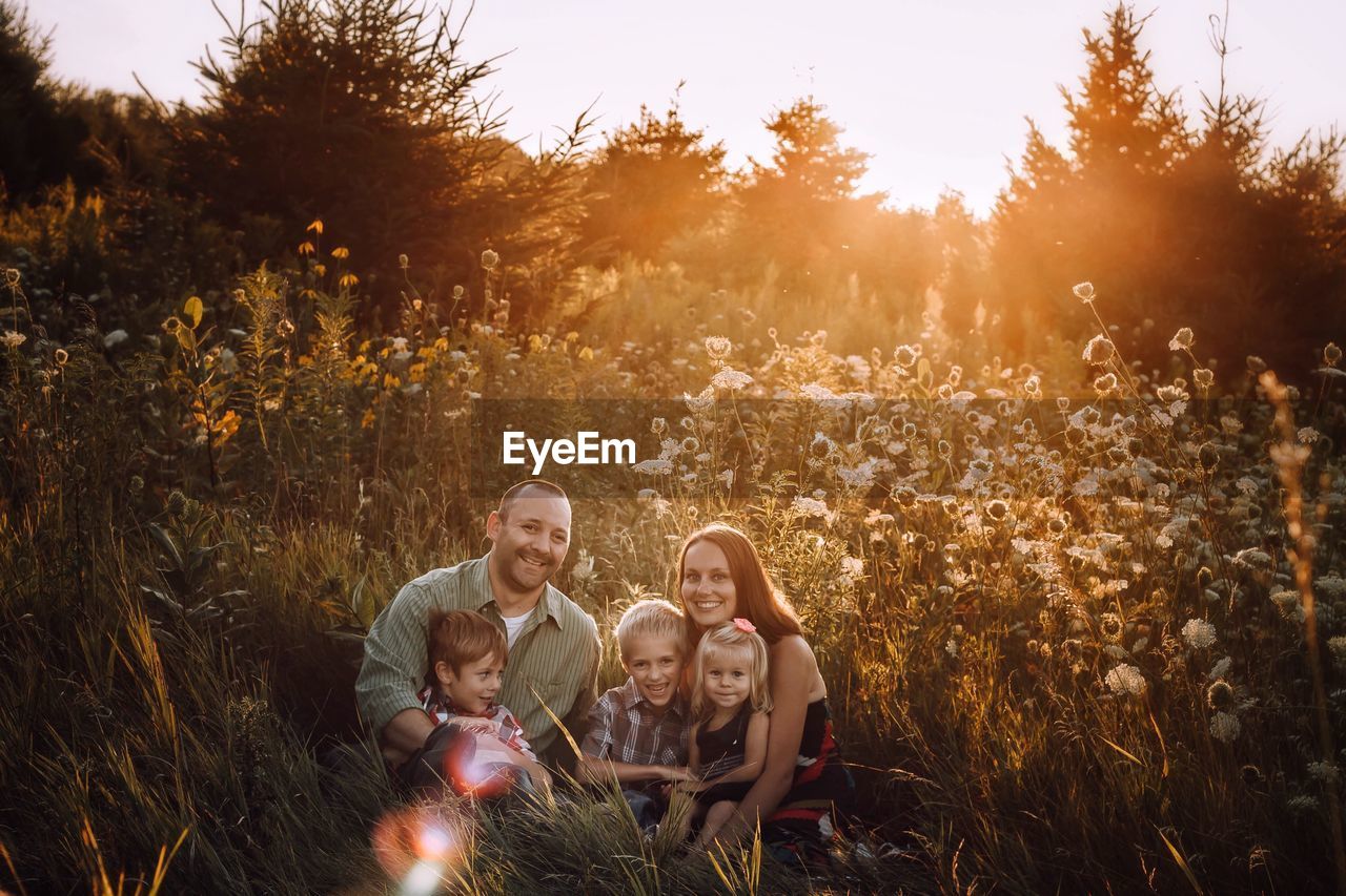 Family sitting on field