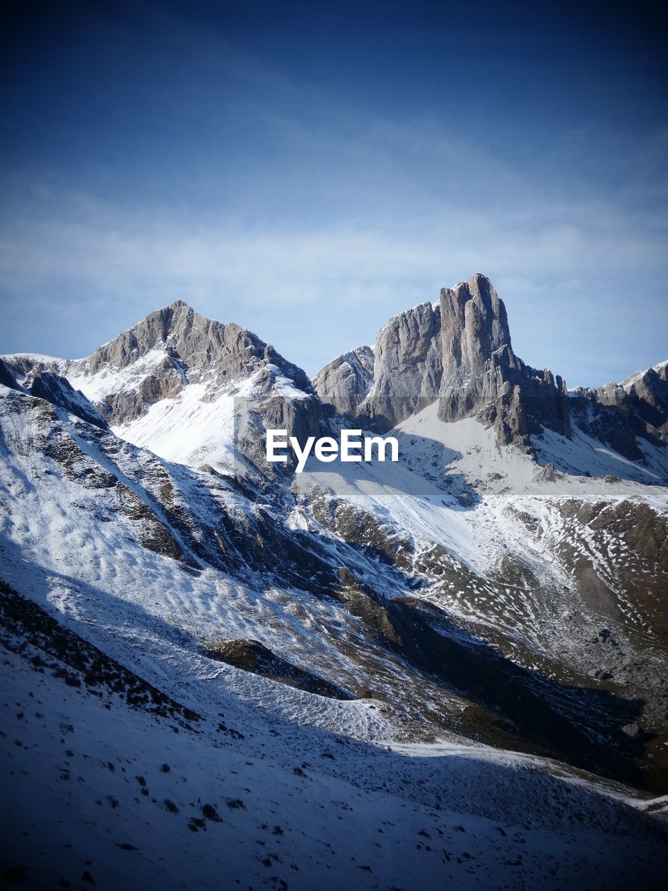 SNOWCAPPED MOUNTAINS AGAINST BLUE SKY