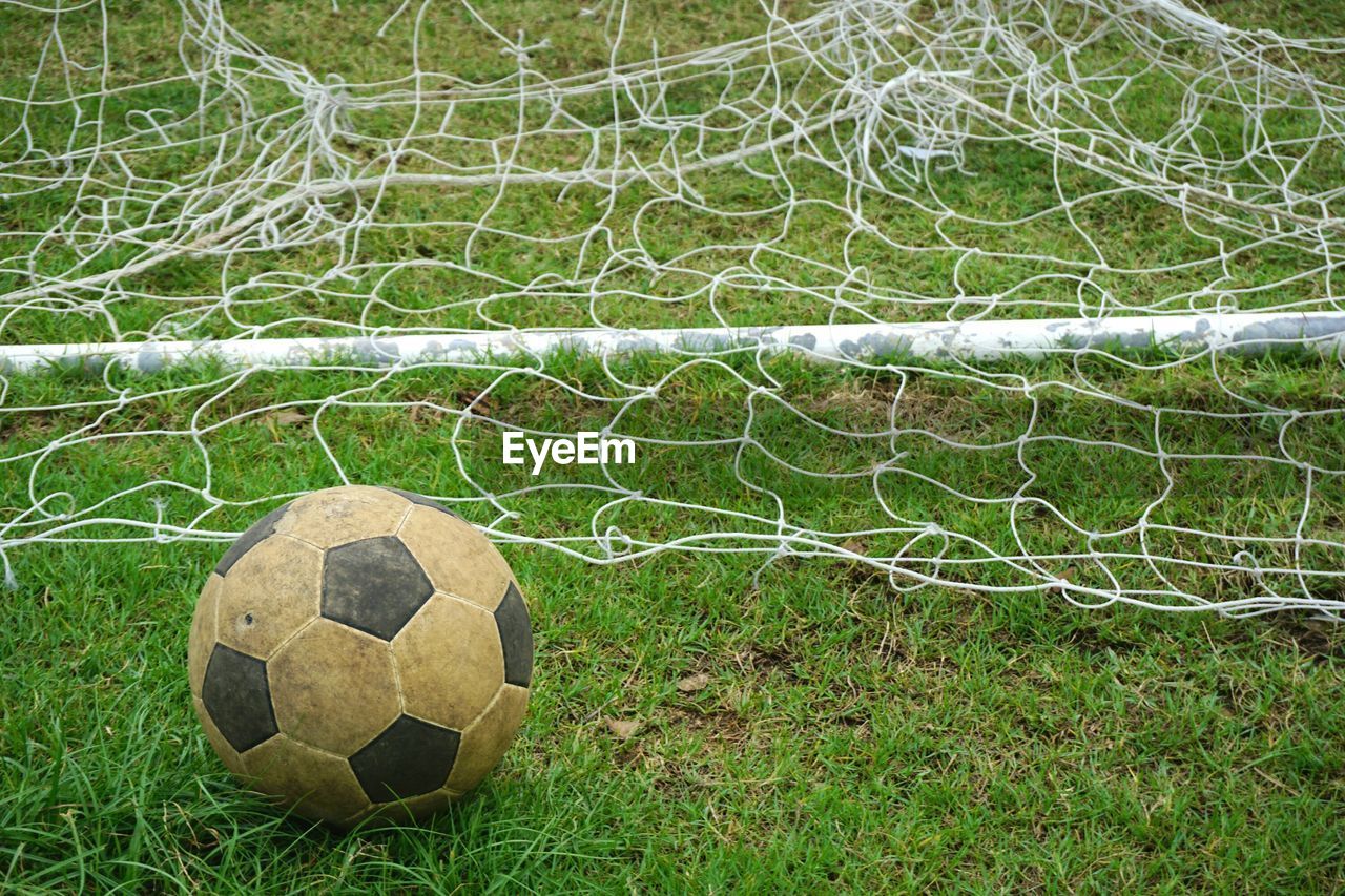 Close-up of soccer ball on grassy field