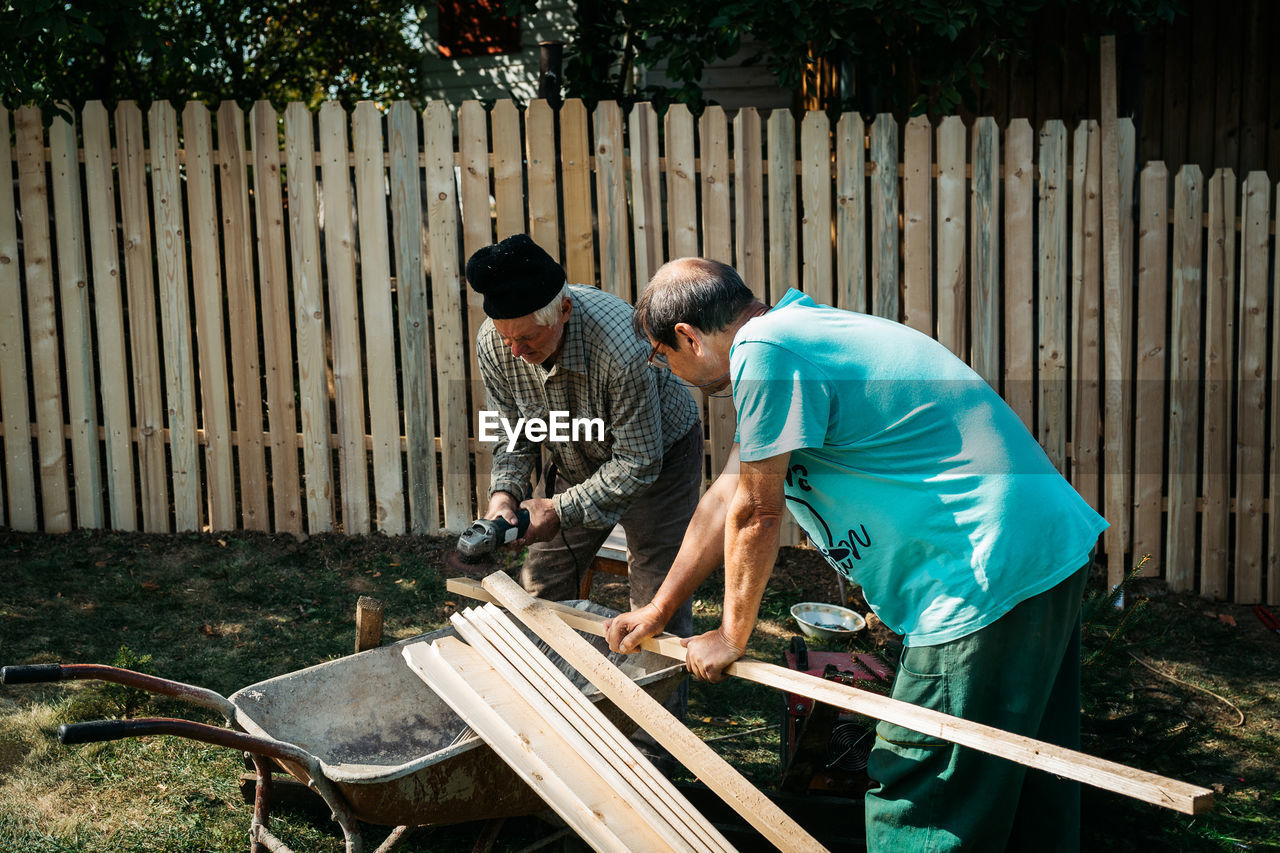 MEN STANDING IN YARD