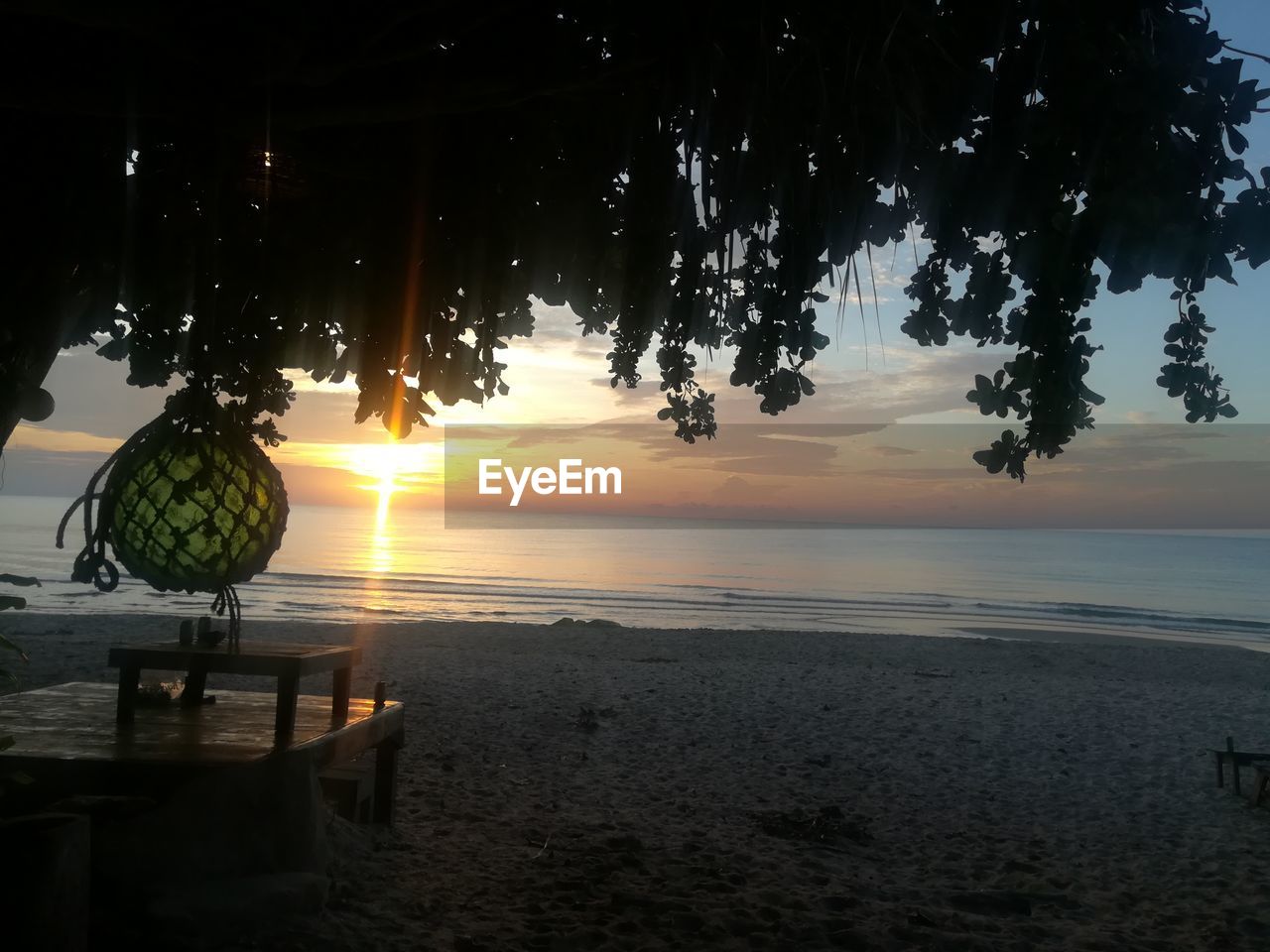 SCENIC VIEW OF BEACH DURING SUNSET