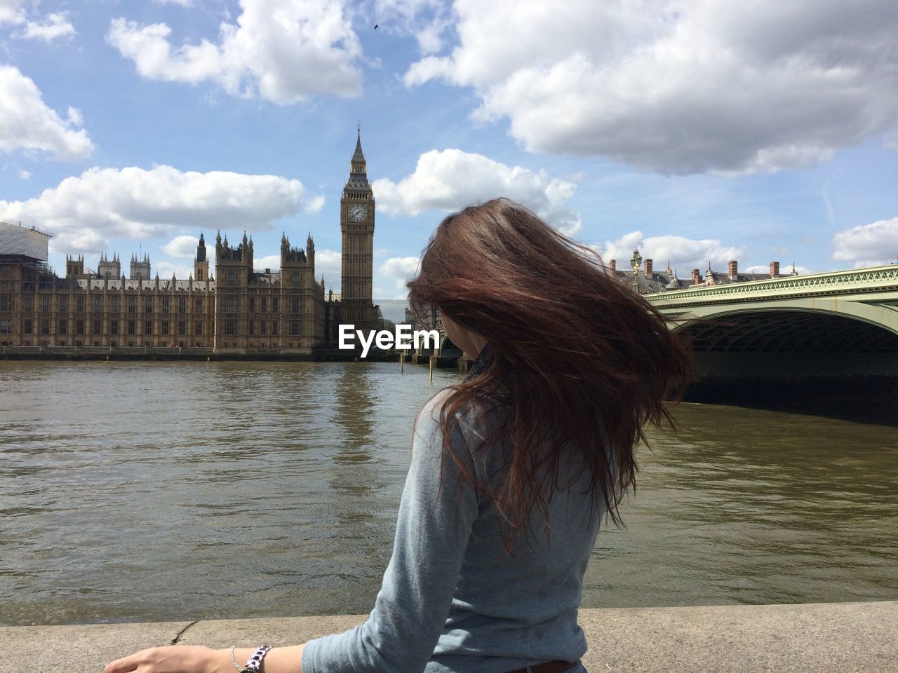 Rear view of woman looking at big ben tower against sky