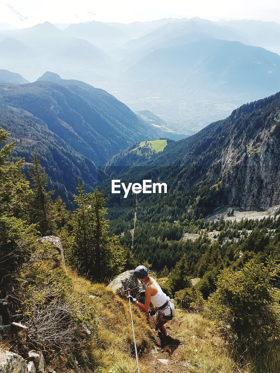 Scenic view of woman climbing rocks in a mountain at heini-holzer-klettersteig